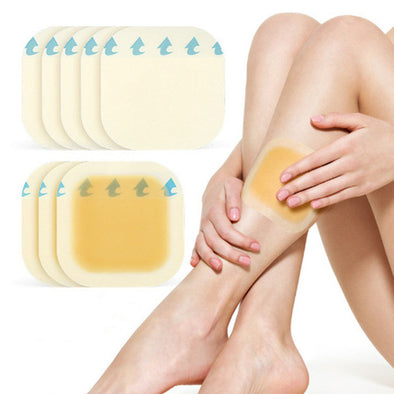Person applying adhesive patches on their leg with additional patches displayed above.